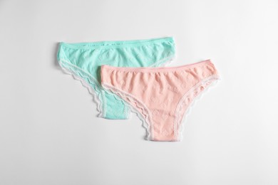 Photo of Women's underwear. Beautiful panties on white background, flat lay
