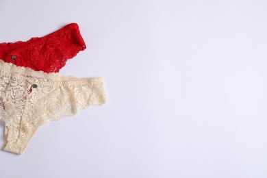 Photo of Women's underwear. Beautiful panties on white background, flat lay. Space for text