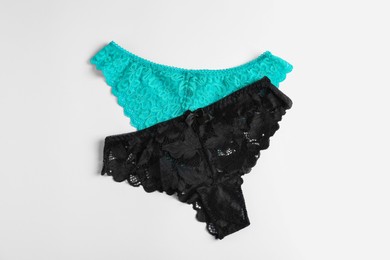 Photo of Women's underwear. Beautiful panties on white background, flat lay