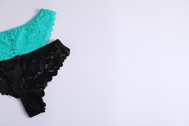 Photo of Women's underwear. Beautiful panties on white background, flat lay. Space for text