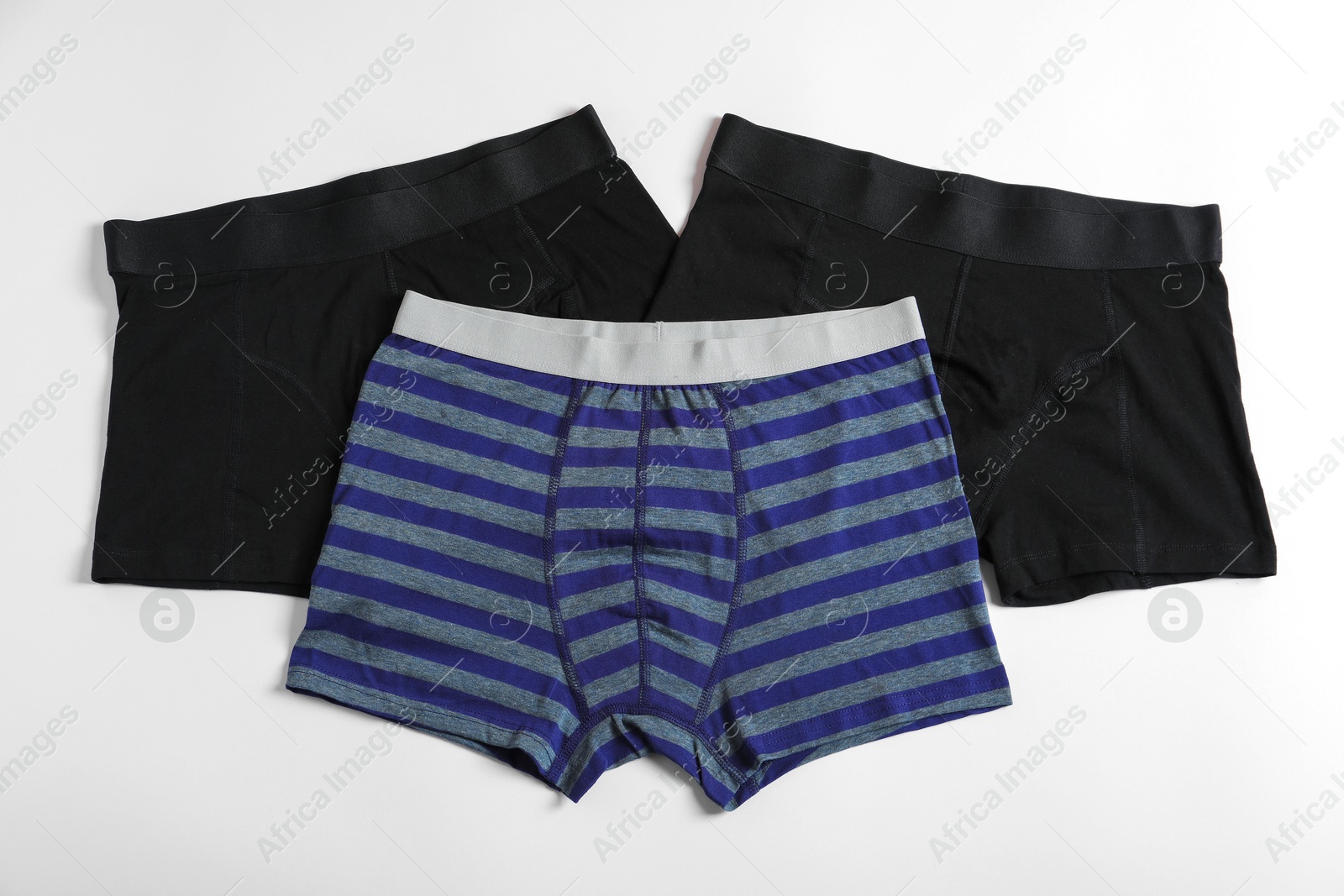 Comfortable men's underwear on white background, flat lay Photo of Comfortable men's underwear on white background, flat lay
