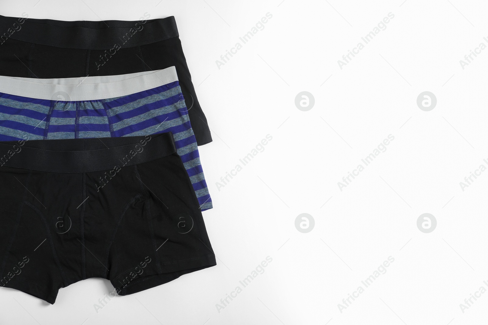 Comfortable men's underwear on white background, flat lay. Space for text Photo of Comfortable men's underwear on white background, flat lay. Space for text