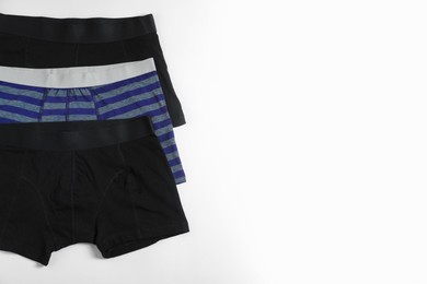 Photo of Comfortable men's underwear on white background, flat lay. Space for text