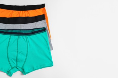 Photo of Comfortable men's underwear on white background, flat lay. Space for text