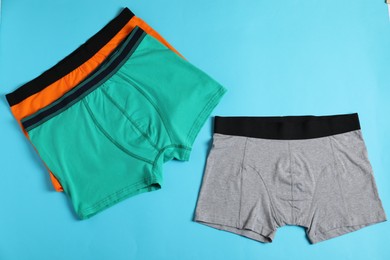 Photo of Comfortable men's underwear on light blue background, flat lay