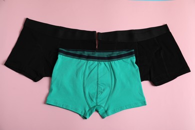 Photo of Comfortable men's underwear on pink background, flat lay
