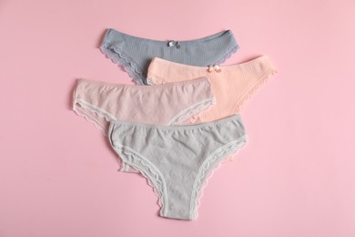 Photo of Women's underwear. Beautiful panties on pink background, flat lay