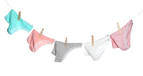 Photo of Women's underwear. Beautiful panties on clothes line against white background