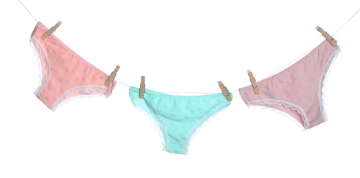 Photo of Women's underwear. Beautiful panties on clothes line against white background