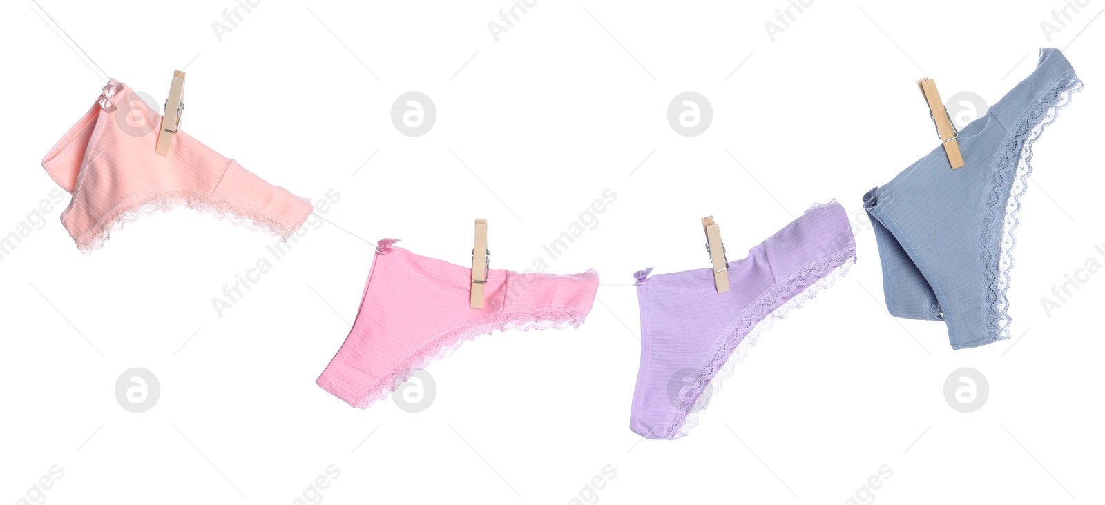 Women's underwear. Beautiful panties on clothes line against white background Photo of Women's underwear. Beautiful panties on clothes line against white background