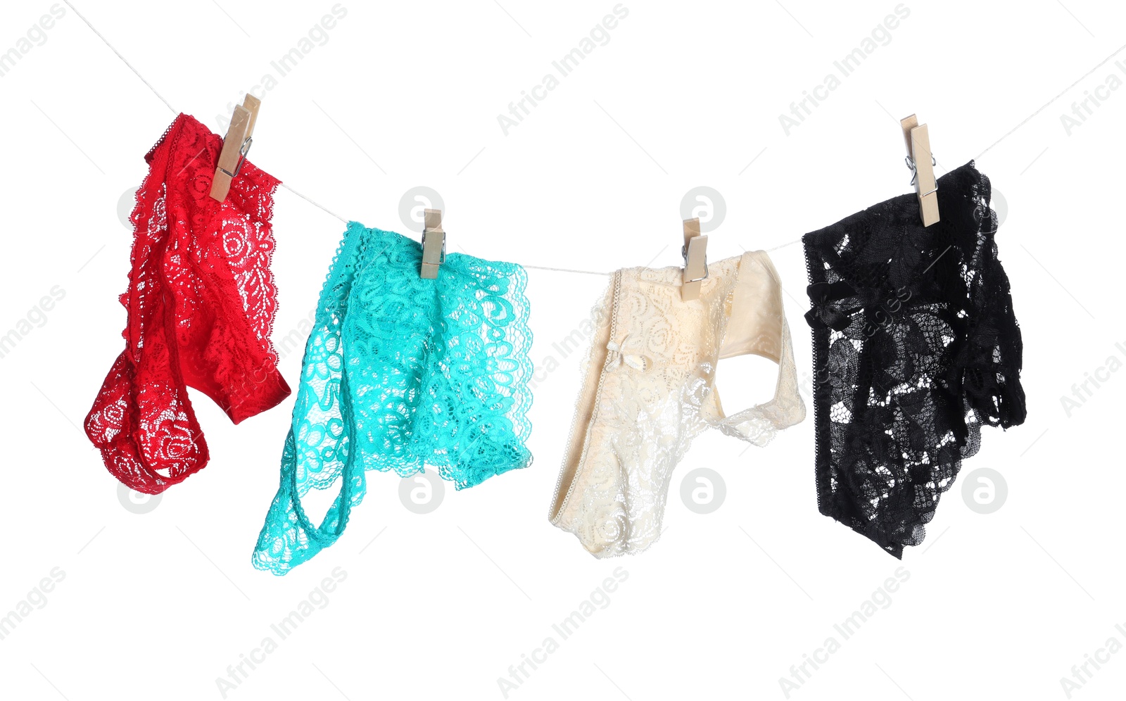 Women's underwear. Beautiful panties on clothes line against white background Photo of Women's underwear. Beautiful panties on clothes line against white background