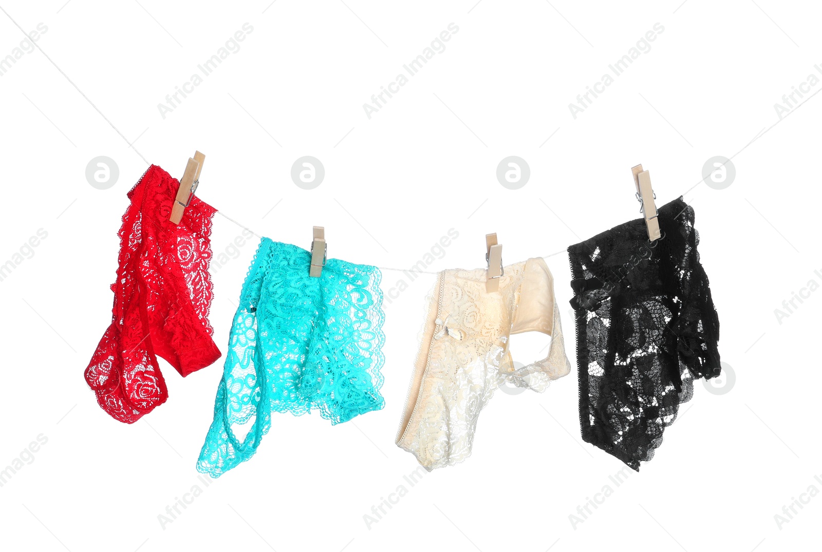 Women's underwear. Beautiful panties on clothes line against white background Photo of Women's underwear. Beautiful panties on clothes line against white background