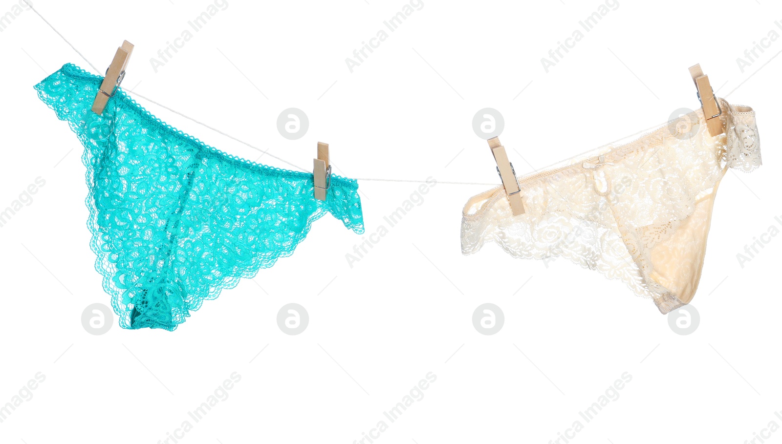 Women's underwear. Beautiful panties on clothes line against white background Photo of Women's underwear. Beautiful panties on clothes line against white background