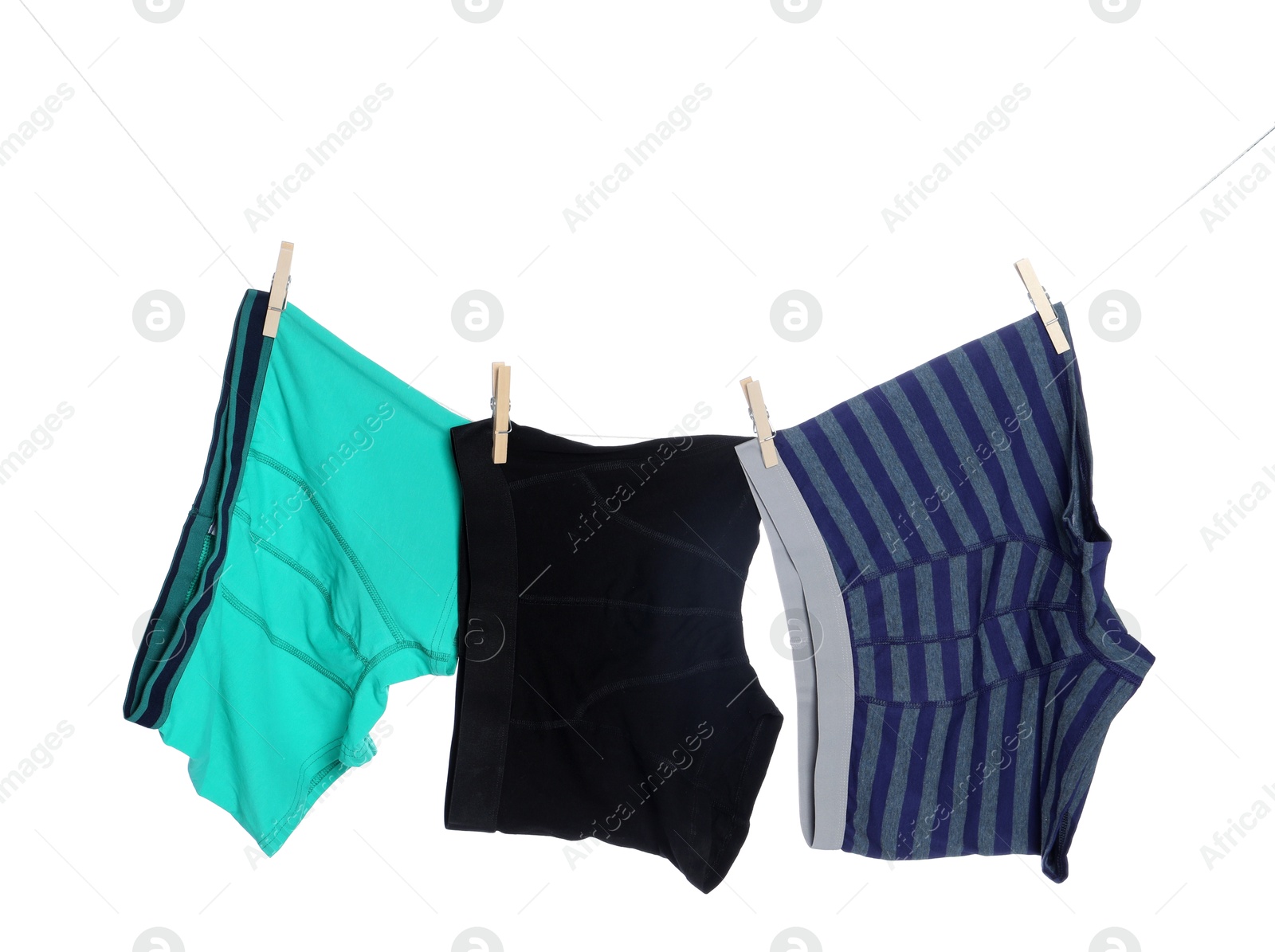 Comfortable men's underwear on clothes line against white background Photo of Comfortable men's underwear on clothes line against white background