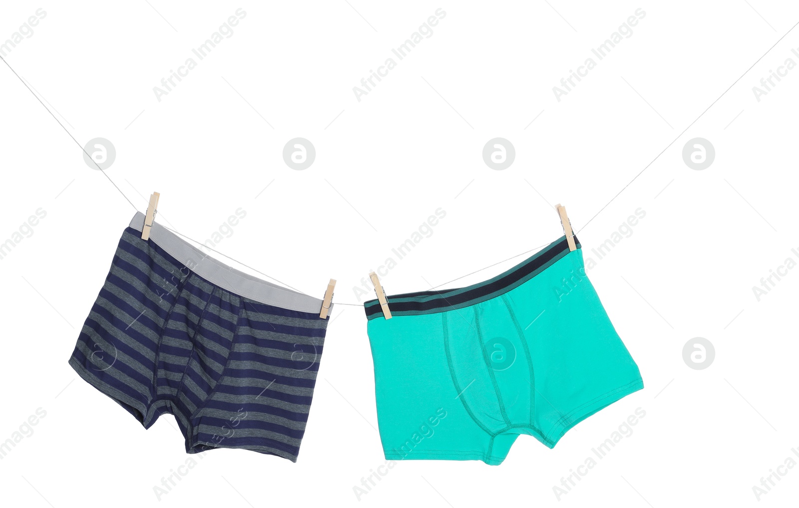Comfortable men's underwear on clothes line against white background Photo of Comfortable men's underwear on clothes line against white background
