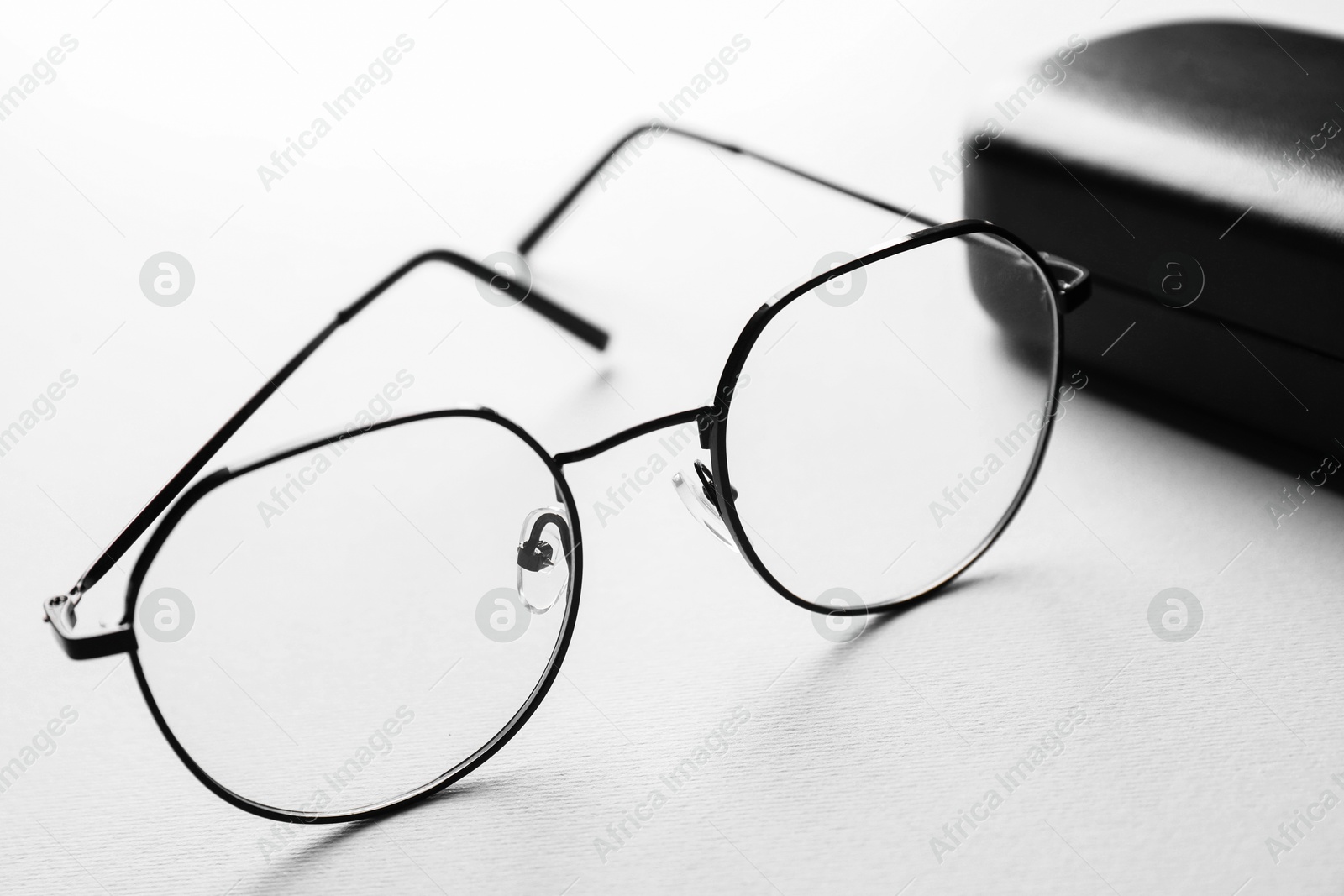 Case with stylish glasses on light background, closeup Photo of Case with stylish glasses on light background, closeup