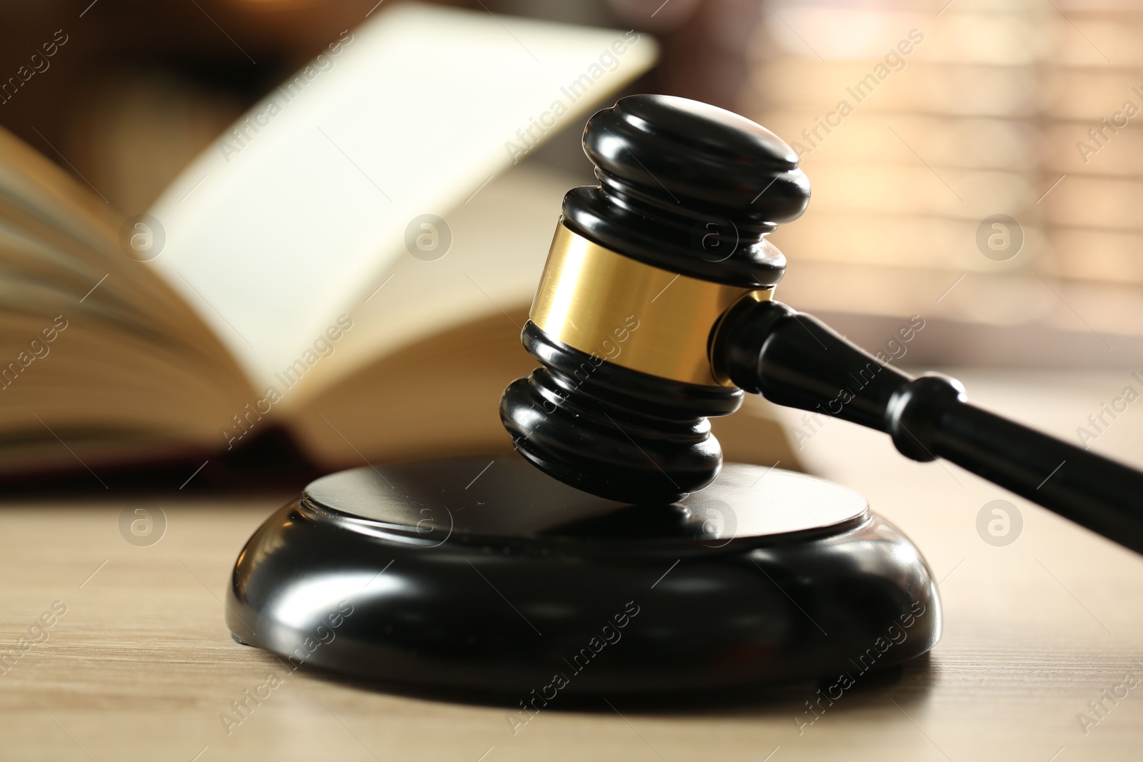 Judge's gavel and book on wooden table indoors, selective focus Photo of Judge's gavel and book on wooden table indoors, selective focus