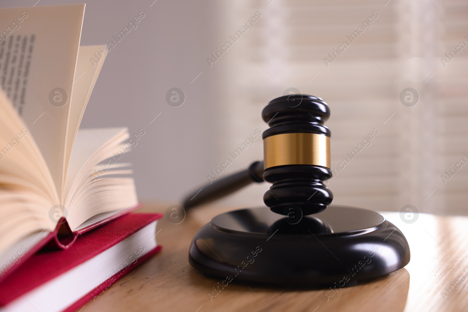 Judge's gavel and books on wooden table indoors, closeup Photo of Judge's gavel and books on wooden table indoors, closeup