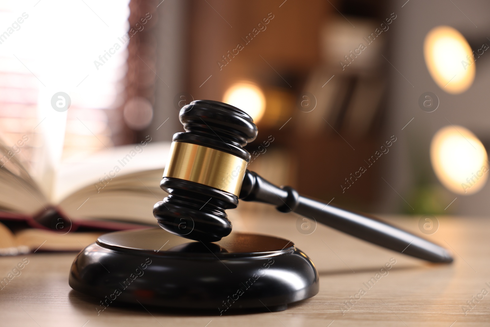 Judge's gavel and book on wooden table indoors, selective focus Photo of Judge's gavel and book on wooden table indoors, selective focus