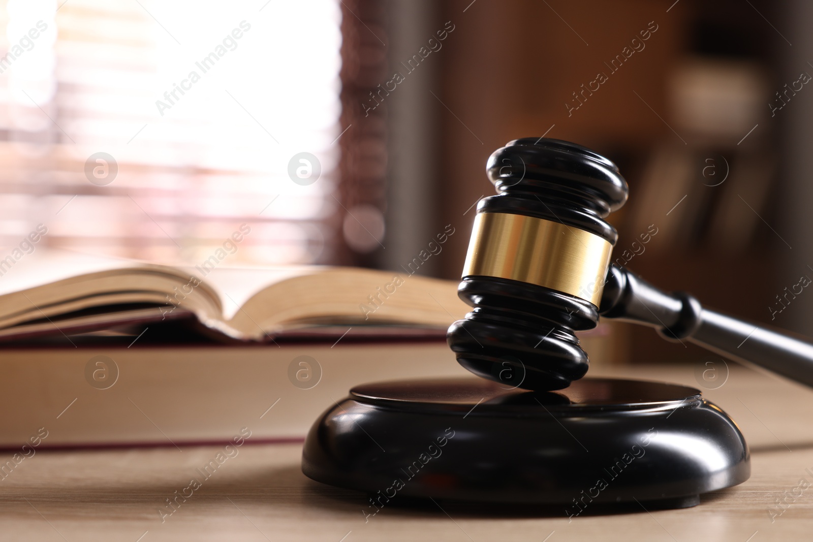 Judge's gavel and book on wooden table indoors, selective focus Photo of Judge's gavel and book on wooden table indoors, selective focus