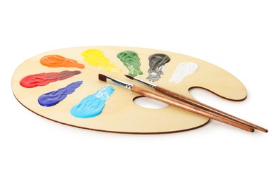 Photo of Wooden palette with paints and brushes isolated on white