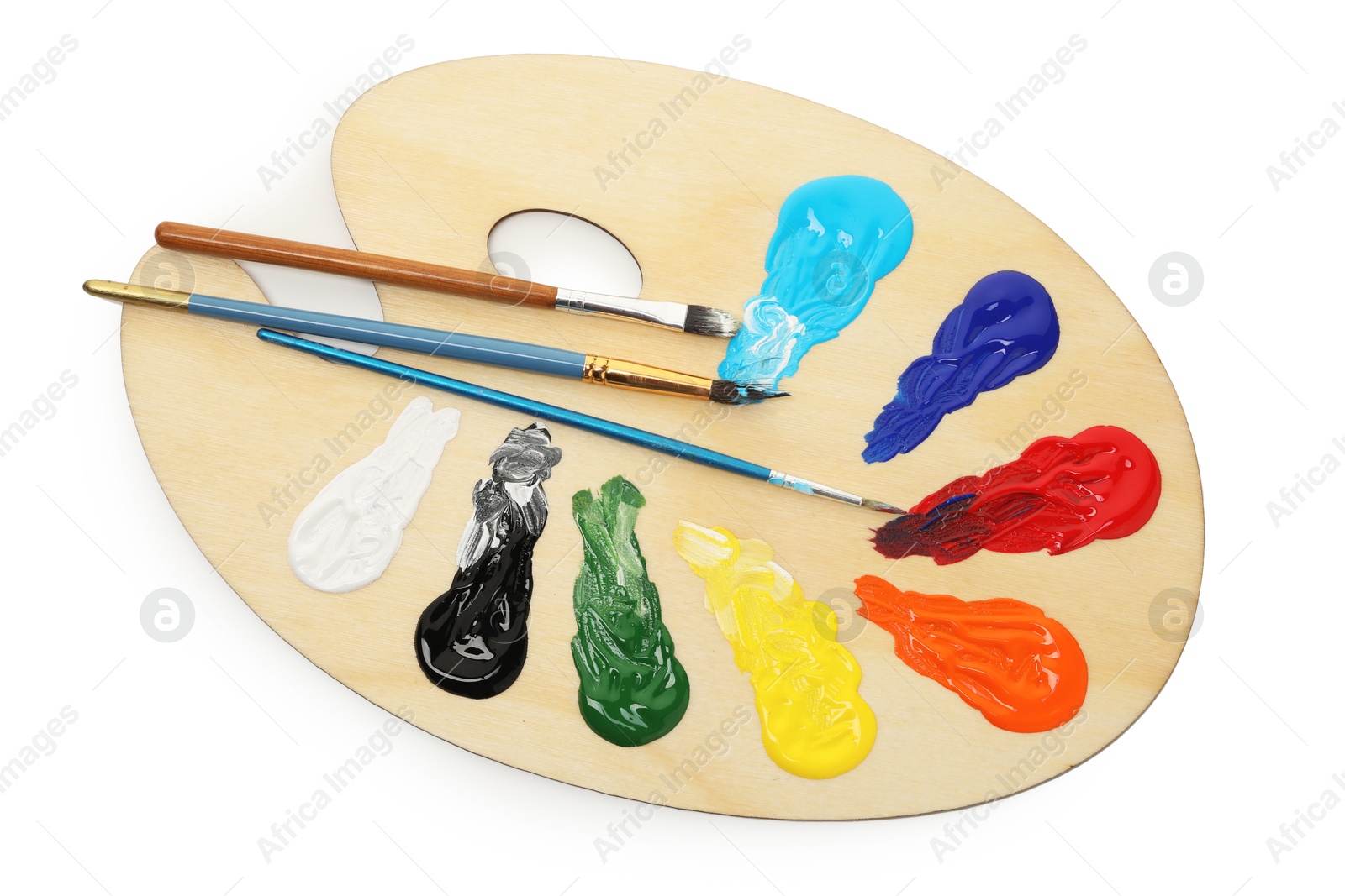 Photo of Wooden palette with paints and brushes isolated on white, top view