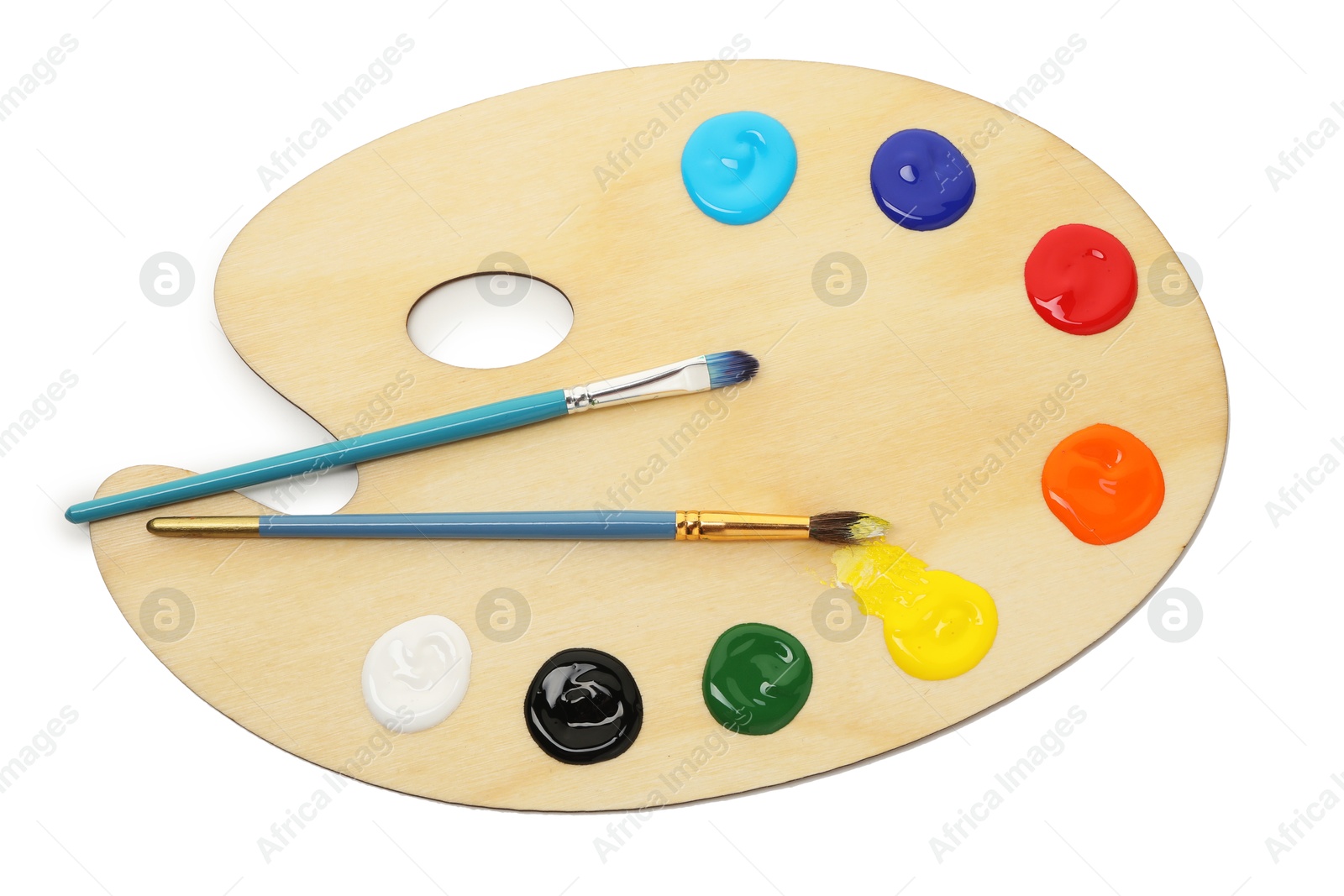 Photo of Wooden palette with paints and brushes isolated on white, top view