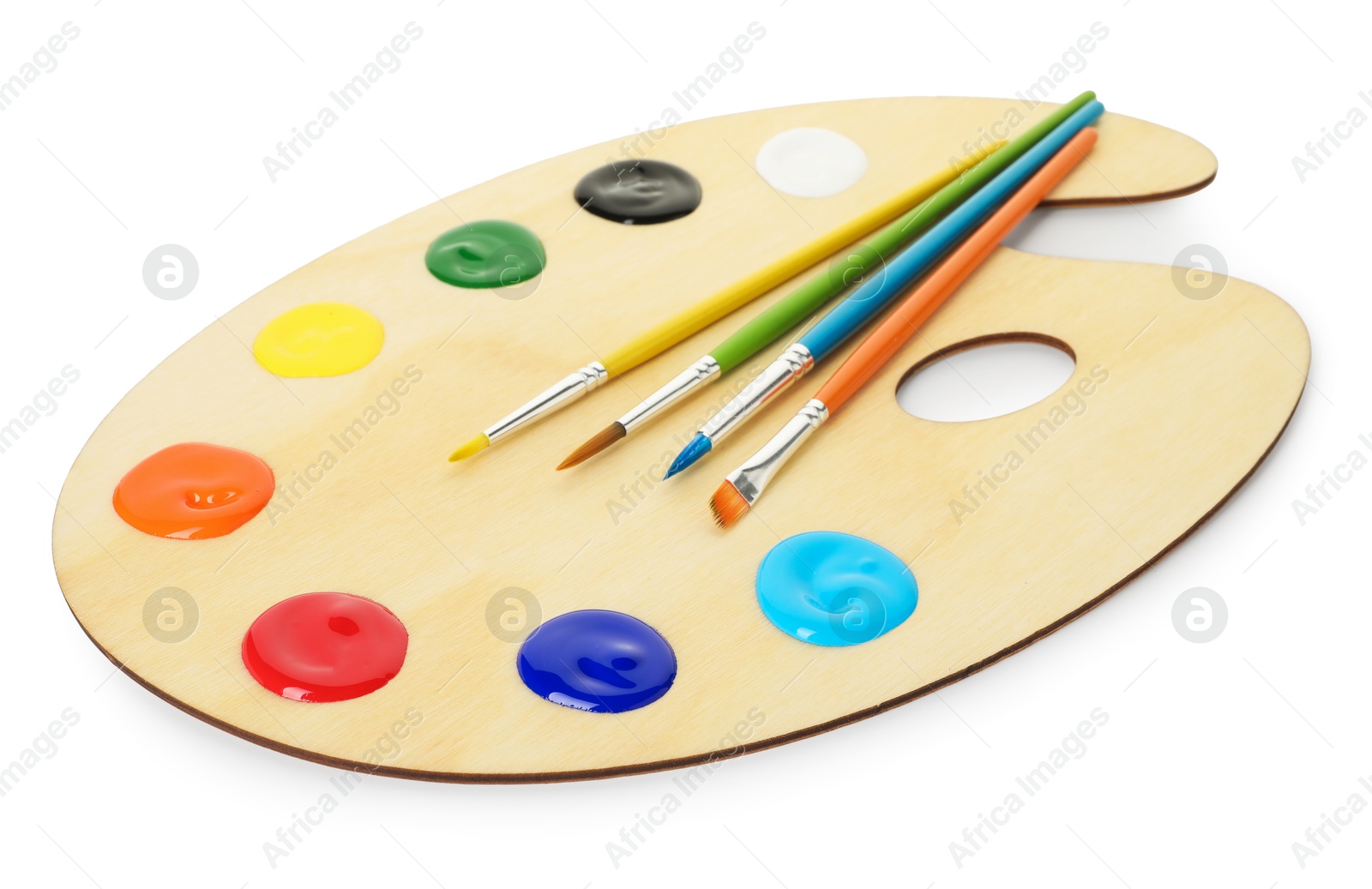 Photo of Wooden palette with paints and brushes isolated on white