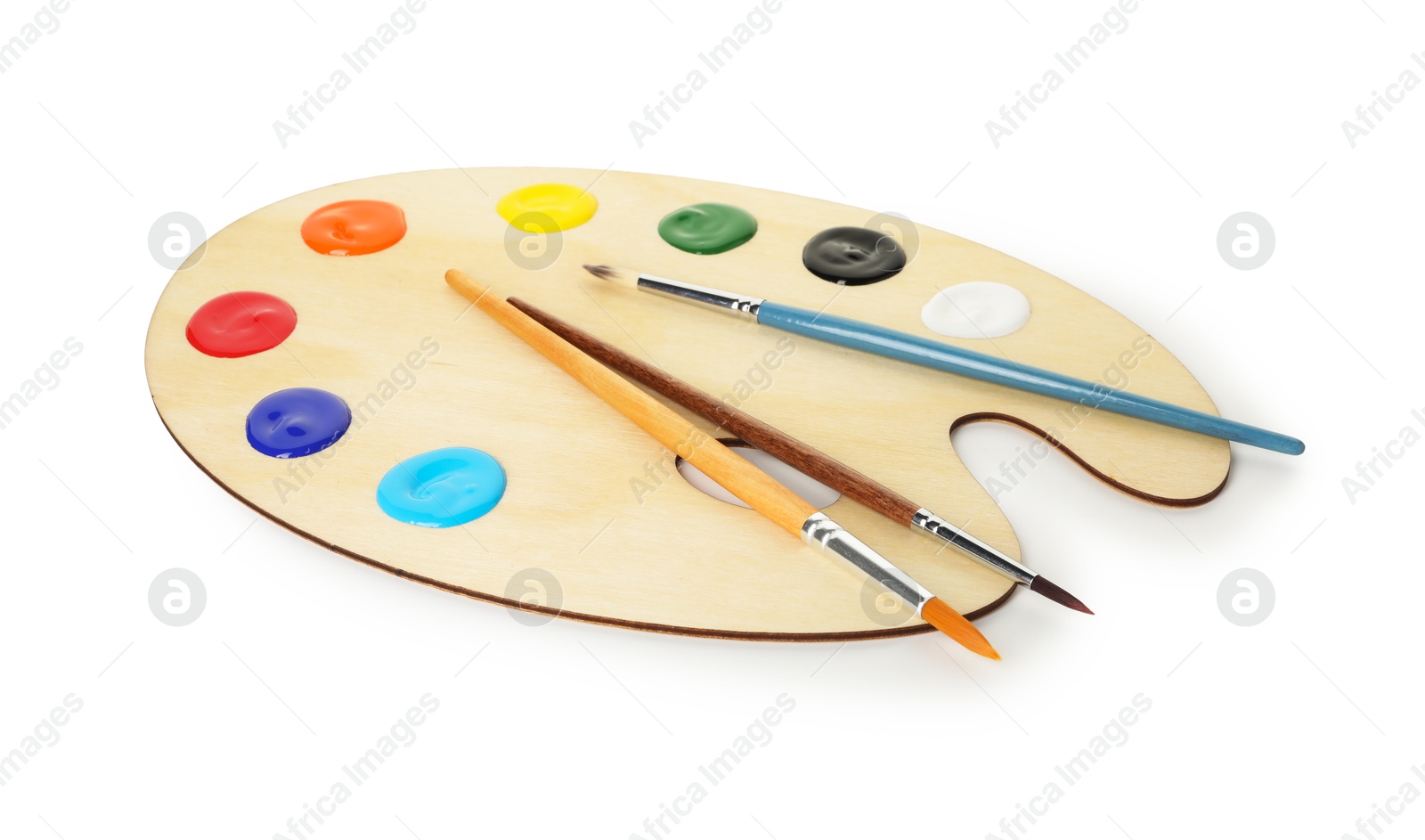 Photo of Wooden palette with paints and brushes isolated on white
