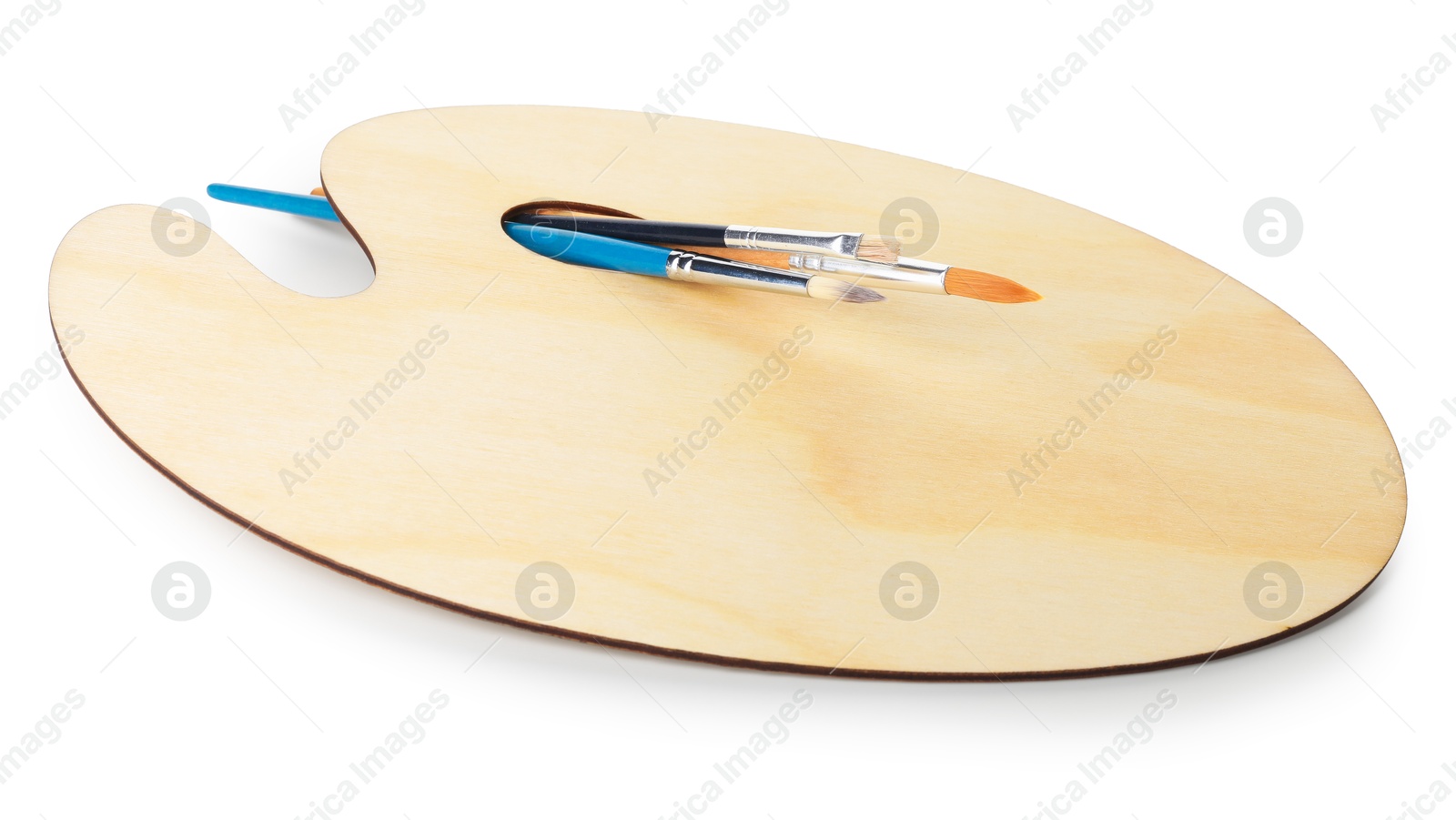 Photo of Wooden palette and brushes isolated on white