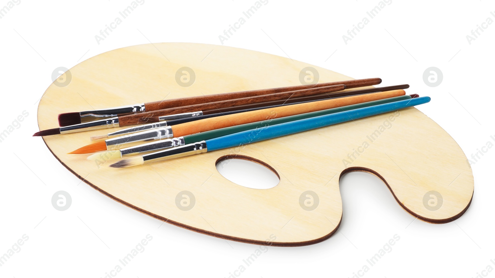 Photo of Wooden palette and brushes isolated on white