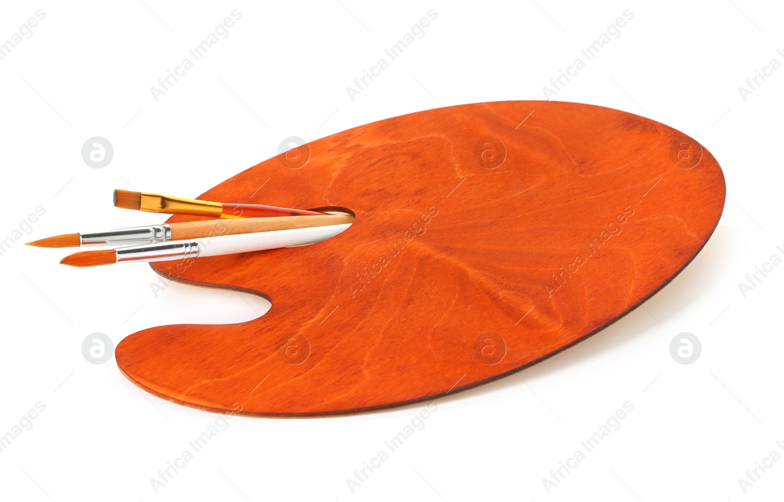 Photo of Wooden palette and brushes isolated on white