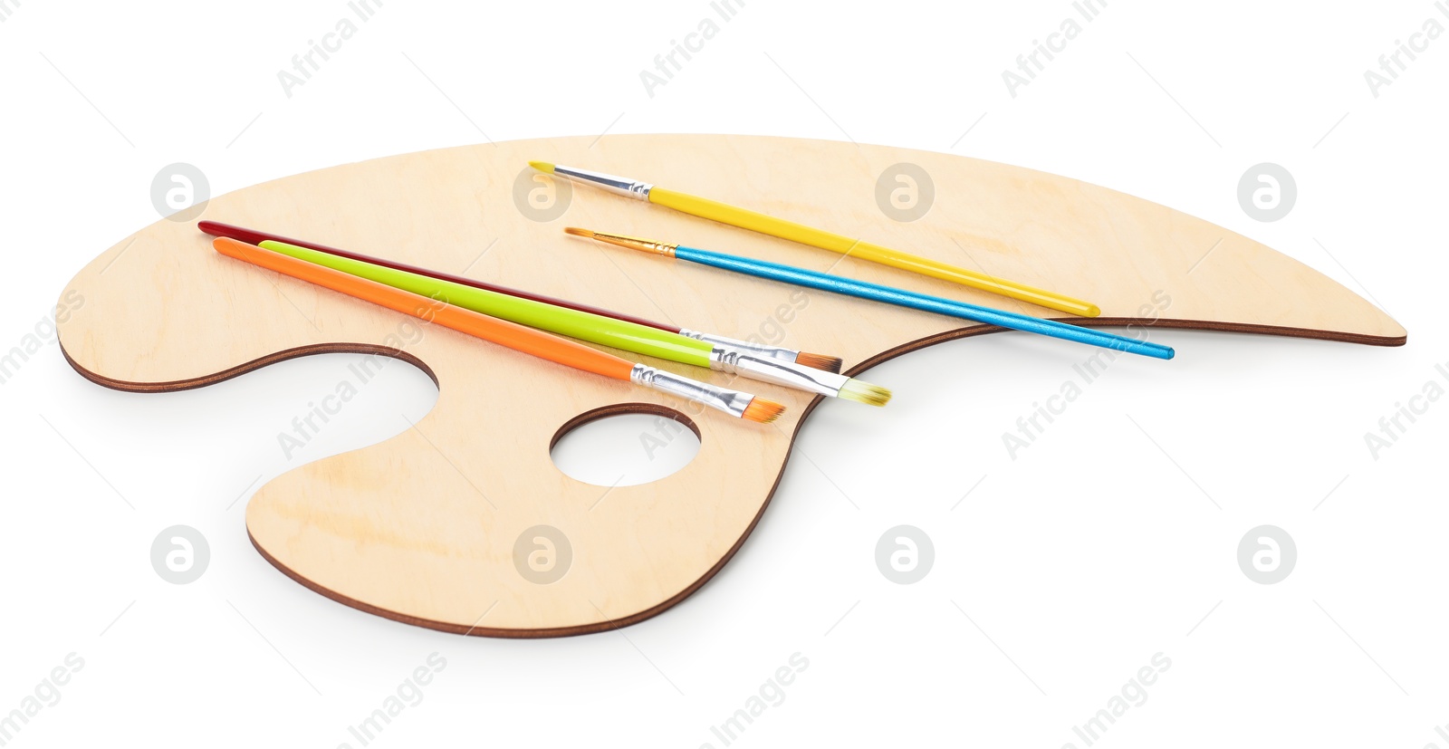 Photo of Wooden palette and brushes isolated on white