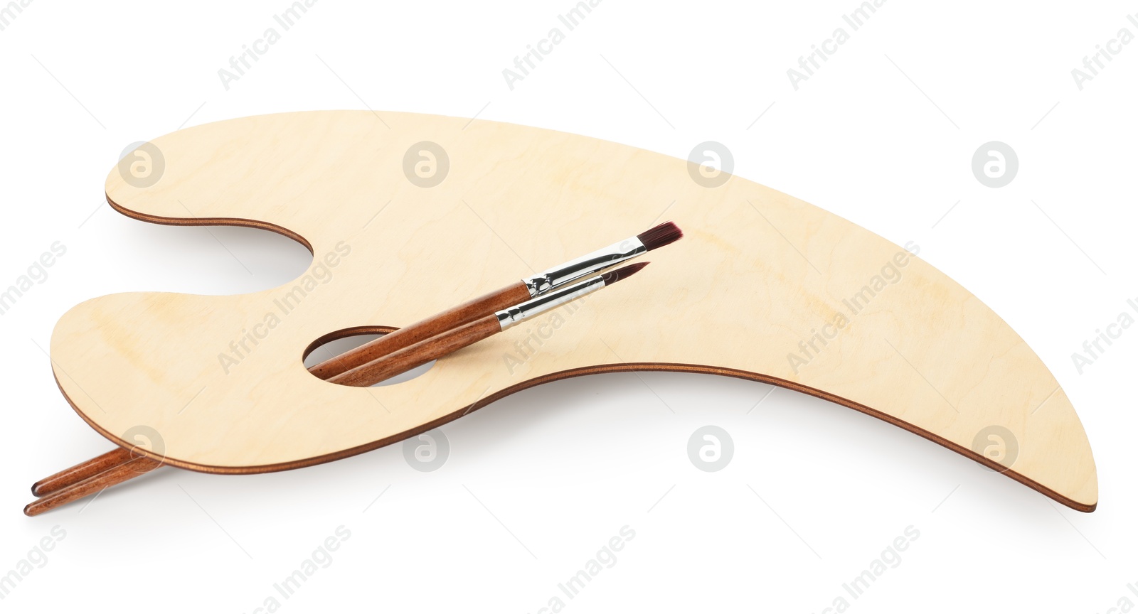 Wooden palette and brushes isolated on white Photo of Wooden palette and brushes isolated on white