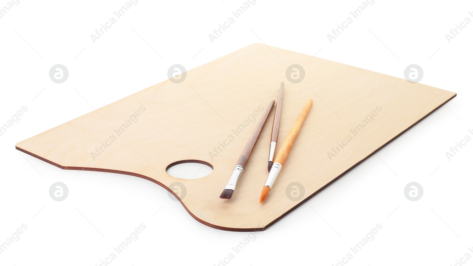 Wooden palette and brushes isolated on white Photo of Wooden palette and brushes isolated on white