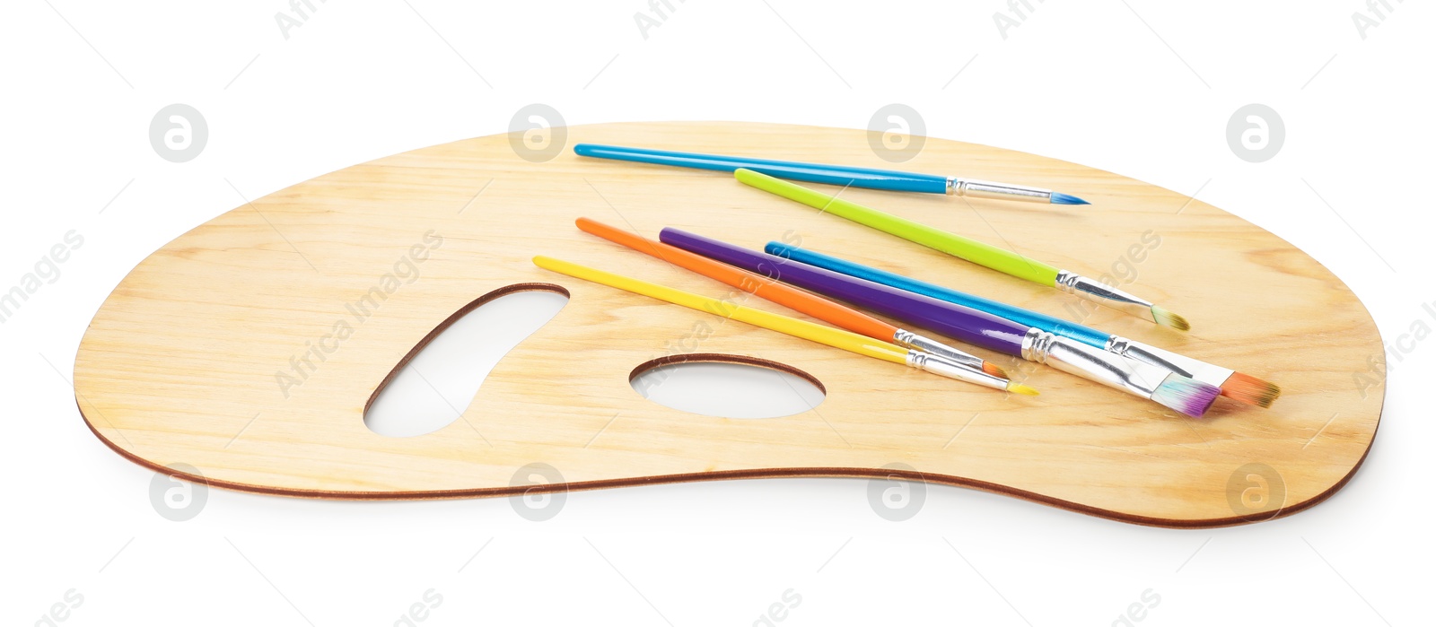 Wooden palette and brushes isolated on white Photo of Wooden palette and brushes isolated on white