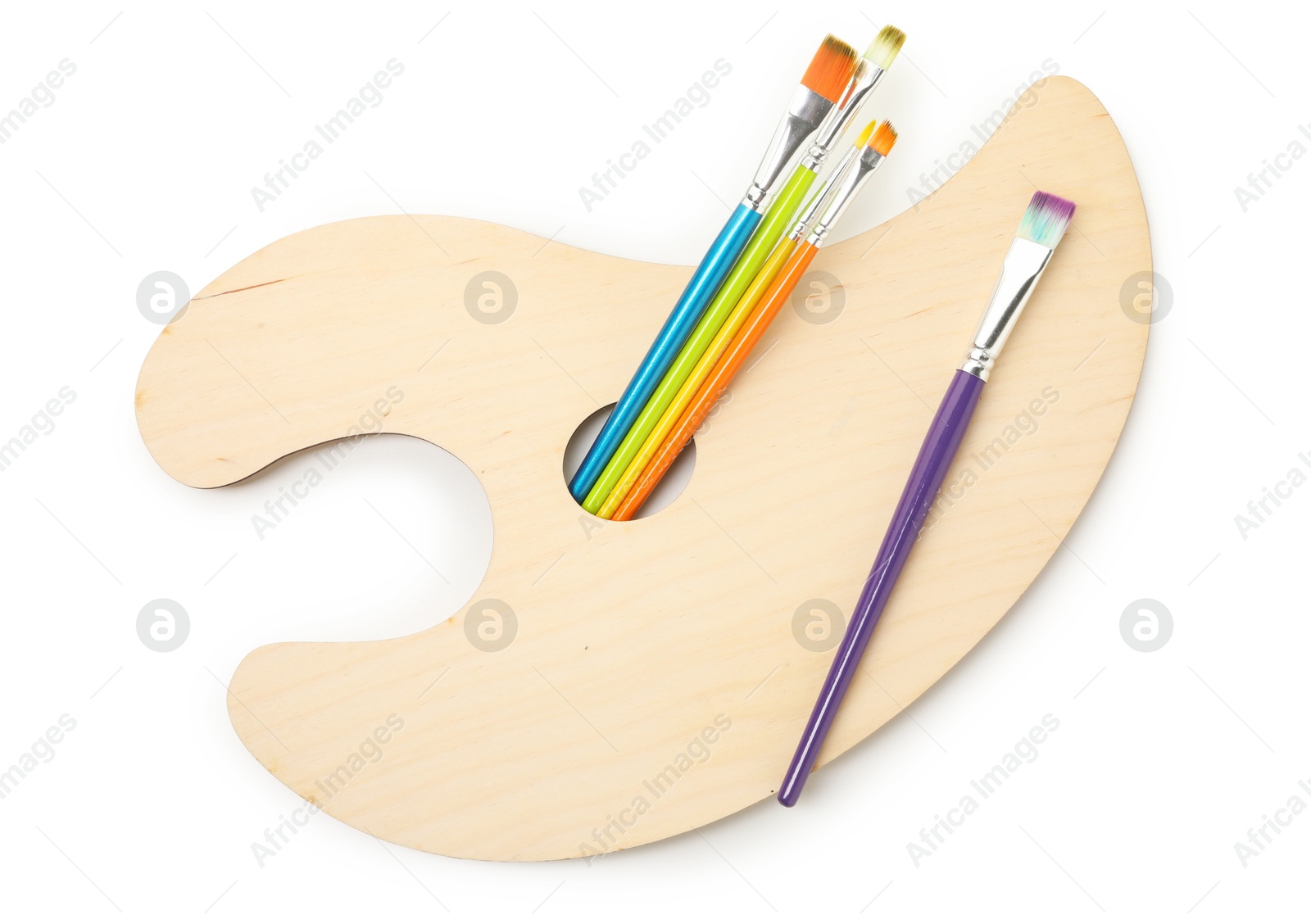 Photo of Wooden palette and brushes isolated on white, top view