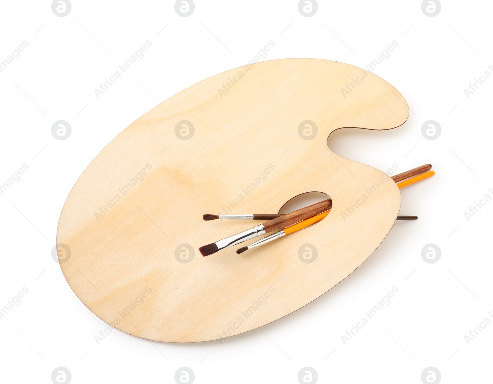 Photo of Wooden palette and brushes isolated on white, top view