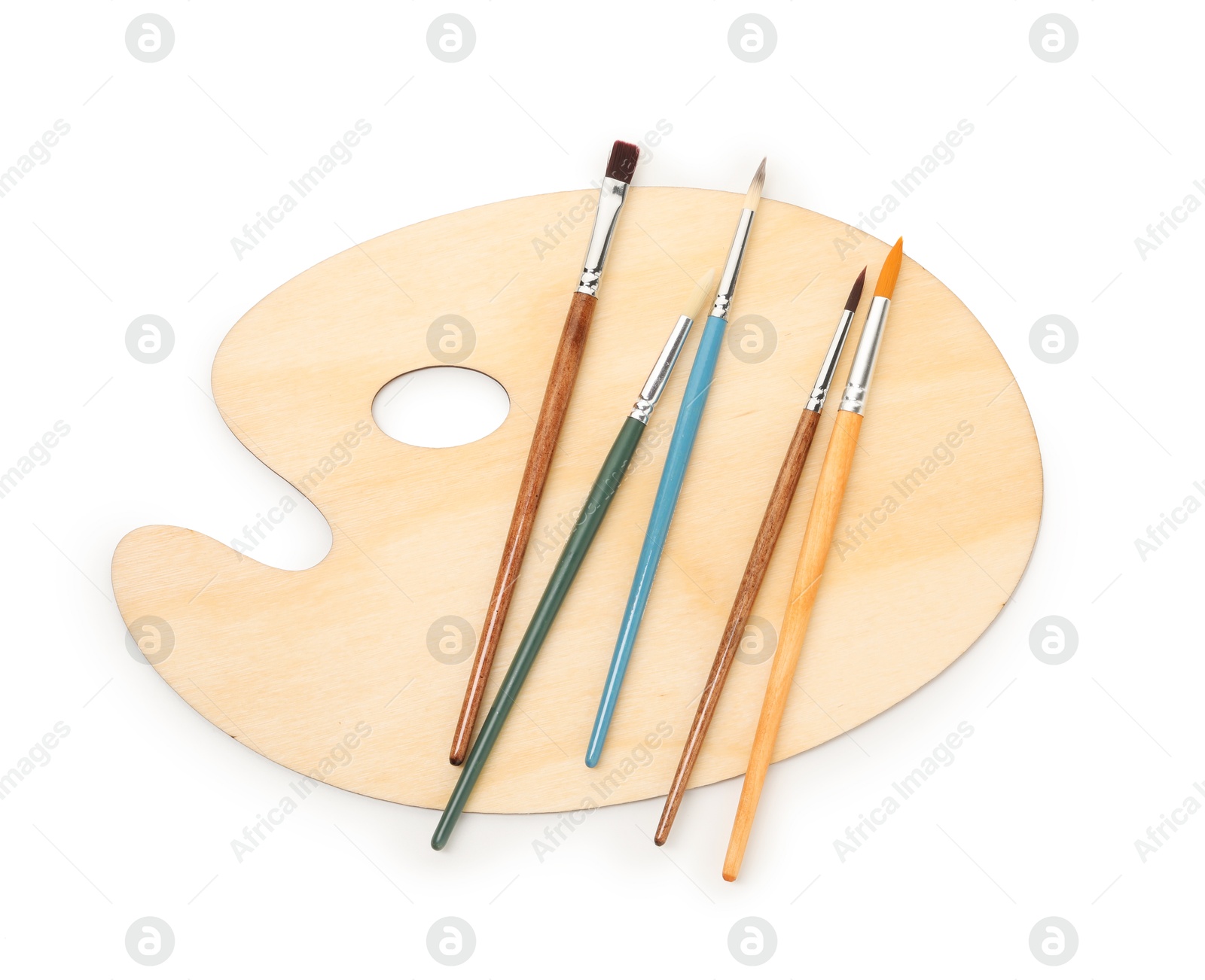 Photo of Wooden palette and brushes isolated on white, top view
