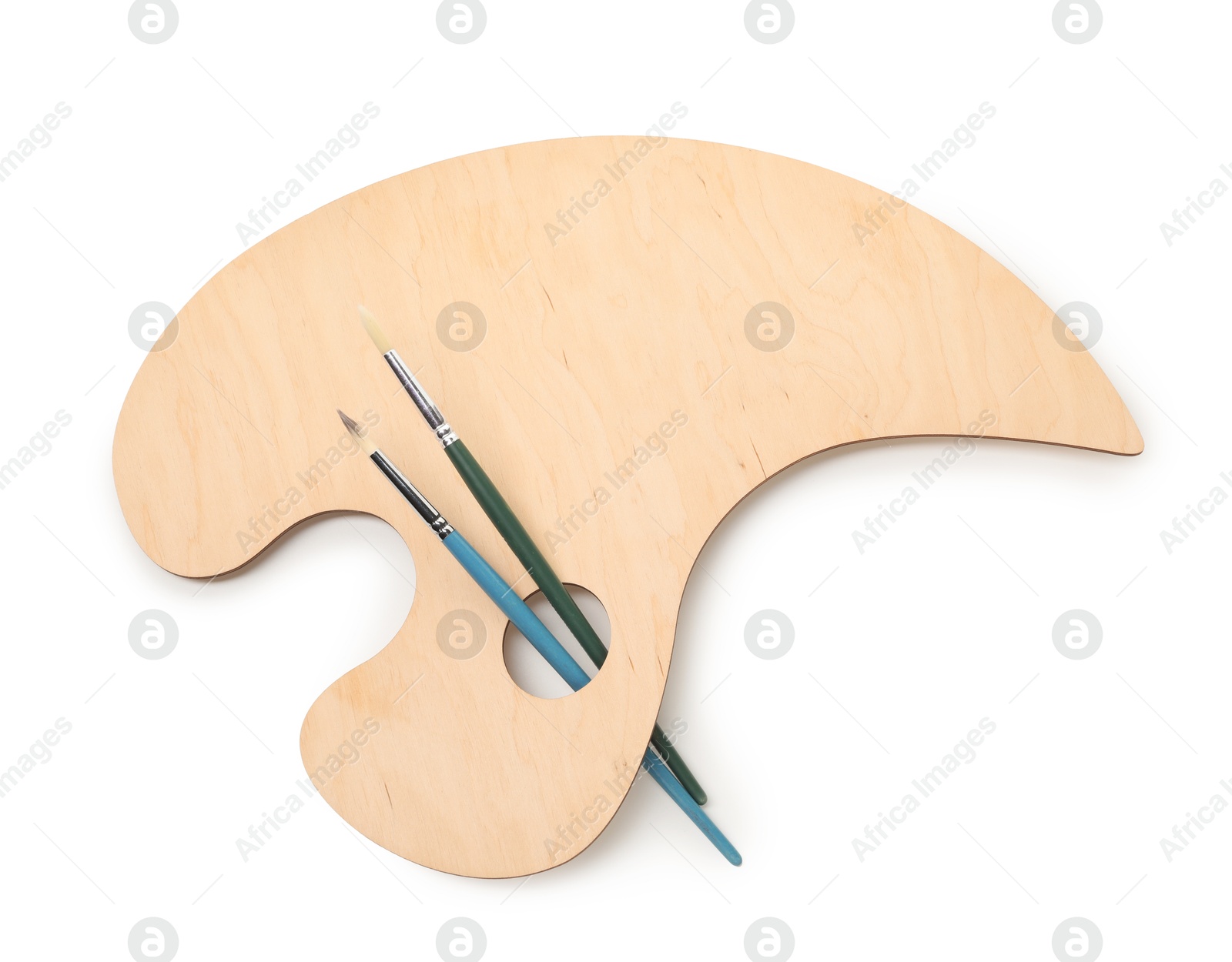 Photo of Wooden palette and brushes isolated on white, top view