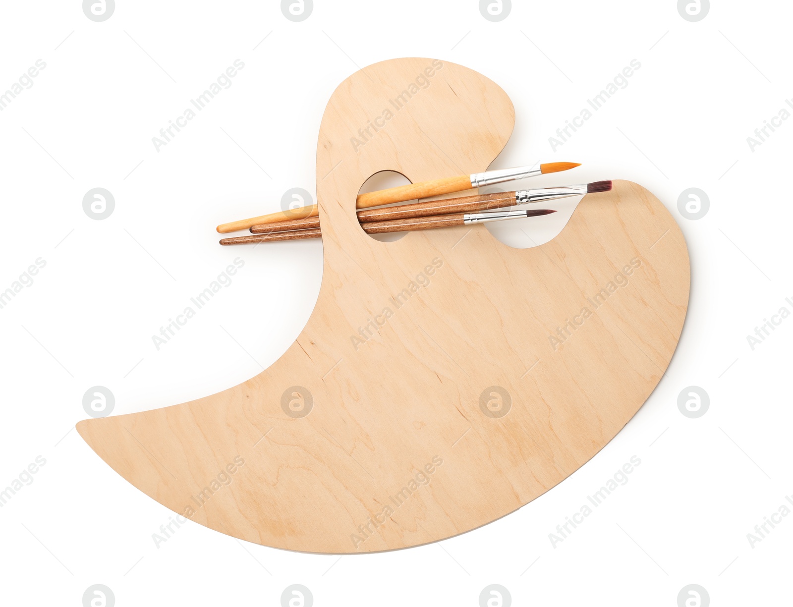 Photo of Wooden palette and brushes isolated on white, top view