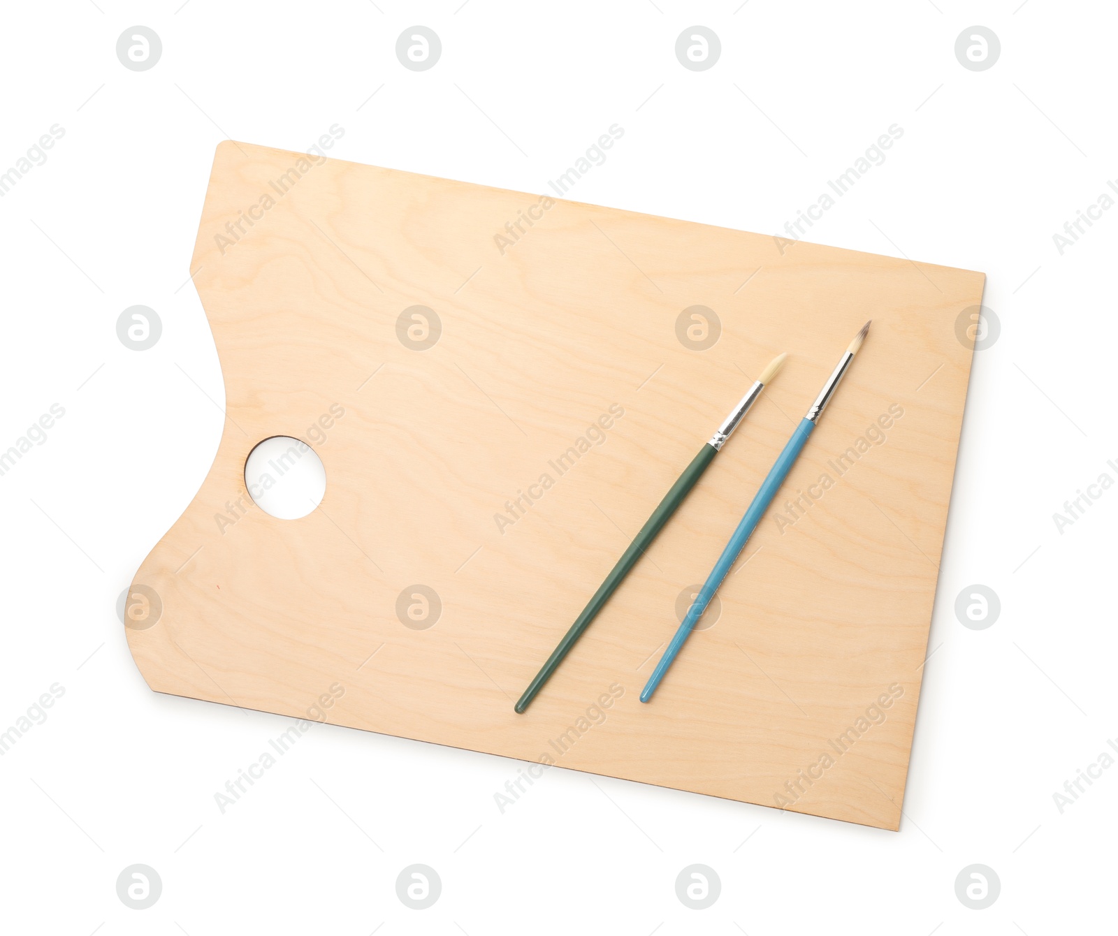Photo of Wooden palette and brushes isolated on white, top view
