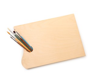 Photo of Wooden palette and brushes isolated on white, top view