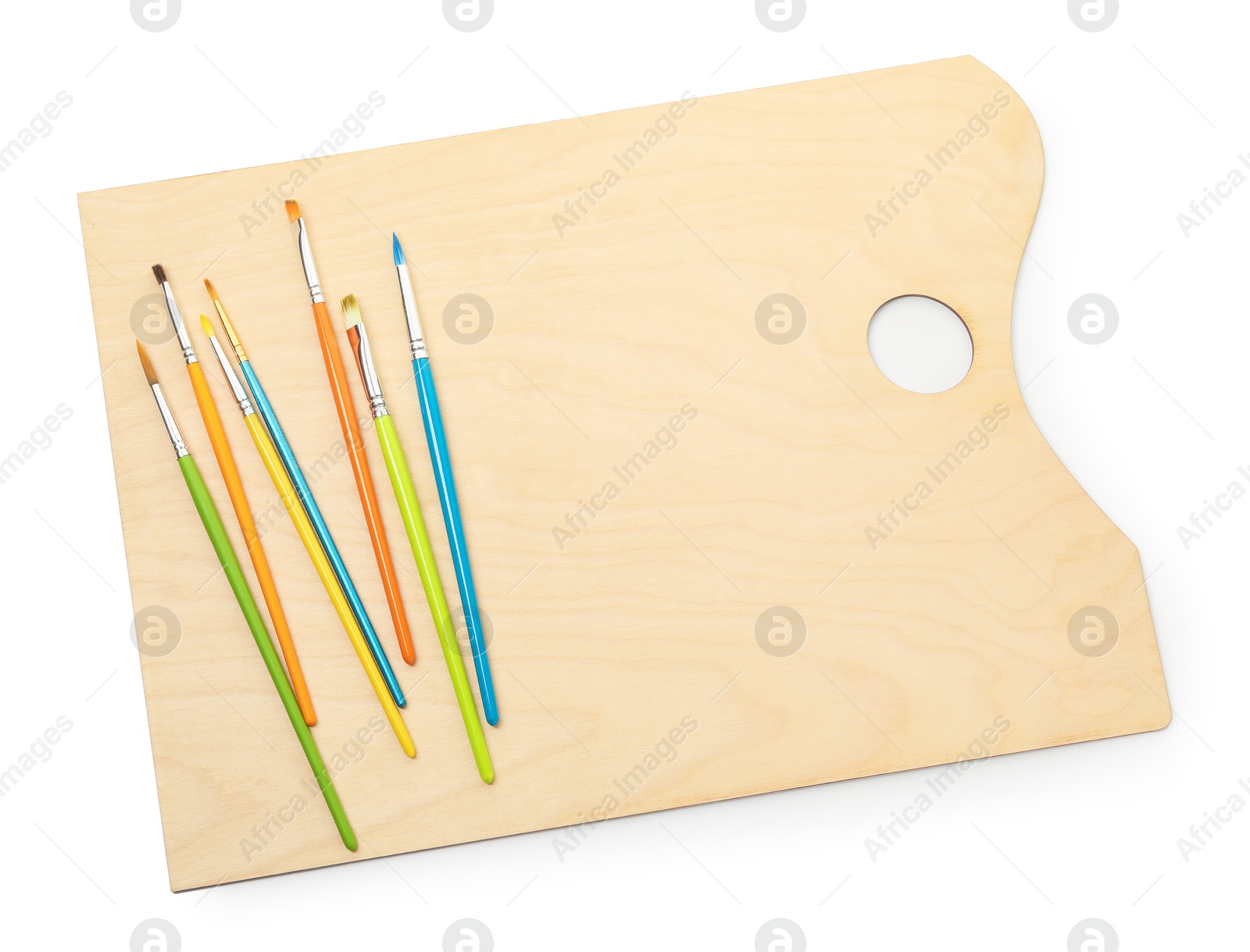 Photo of Wooden palette and brushes isolated on white, top view