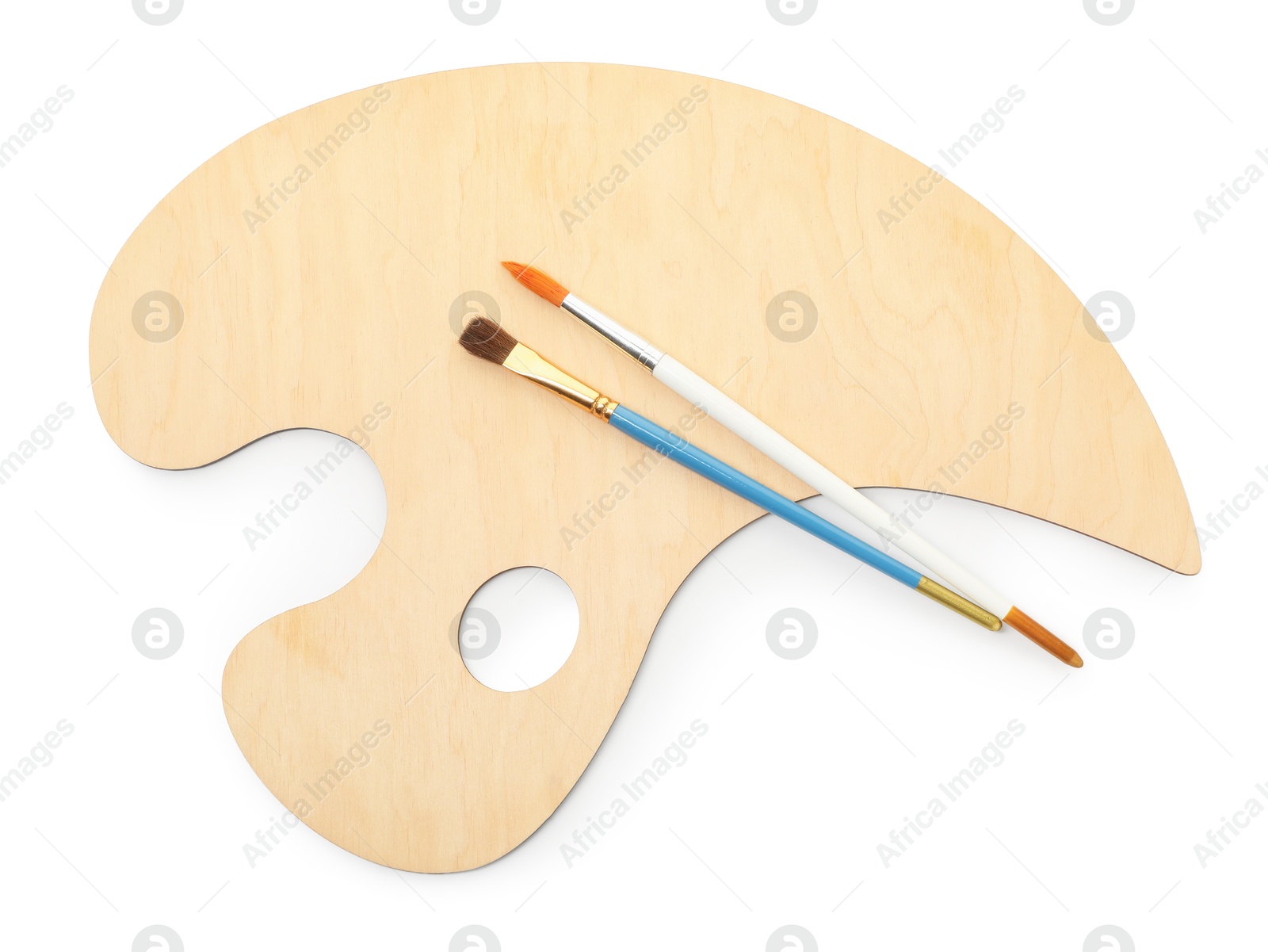 Photo of Wooden palette and brushes isolated on white, top view