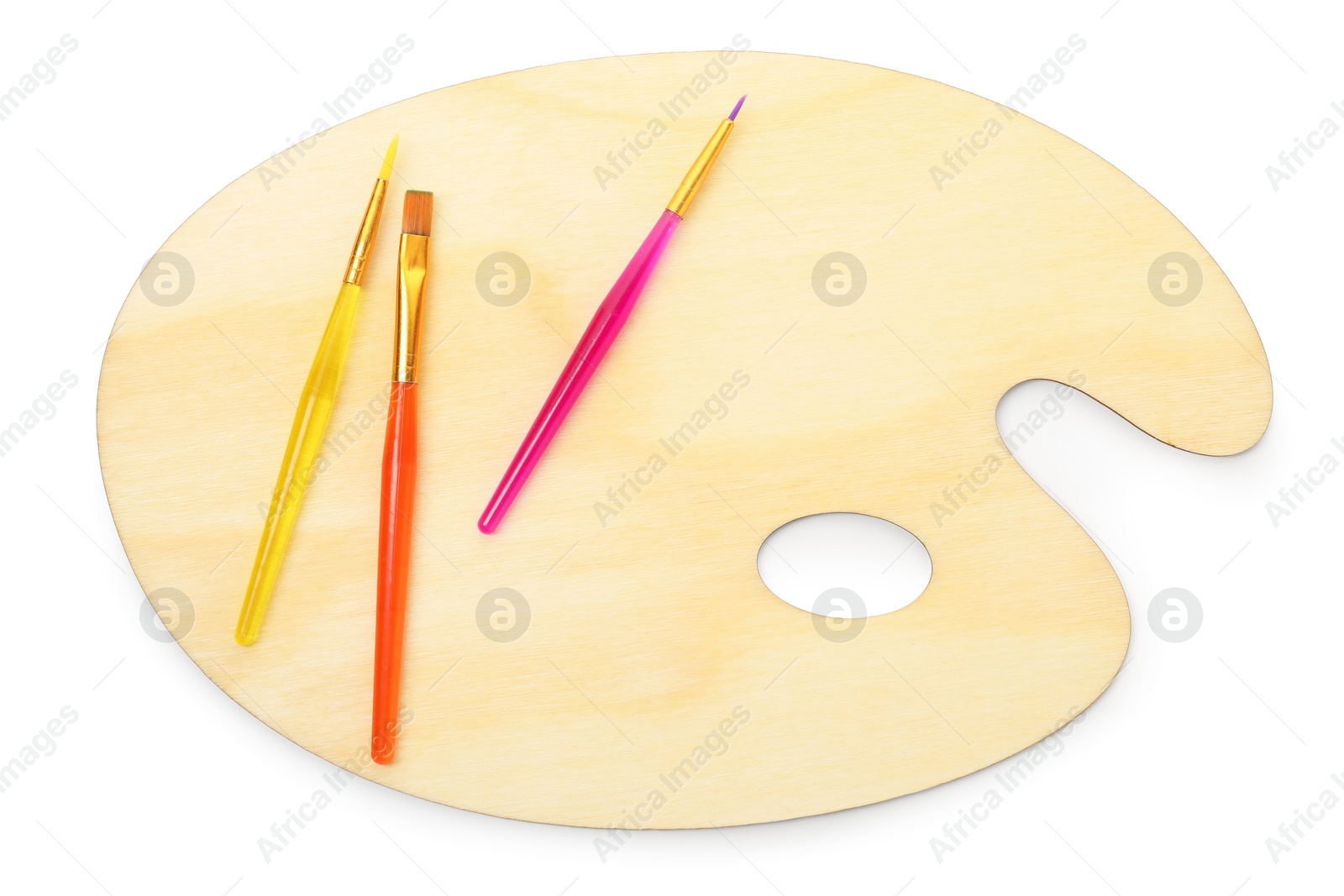 Photo of Wooden palette and brushes isolated on white, top view