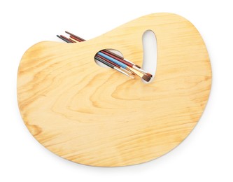 Photo of Wooden palette and brushes isolated on white, top view