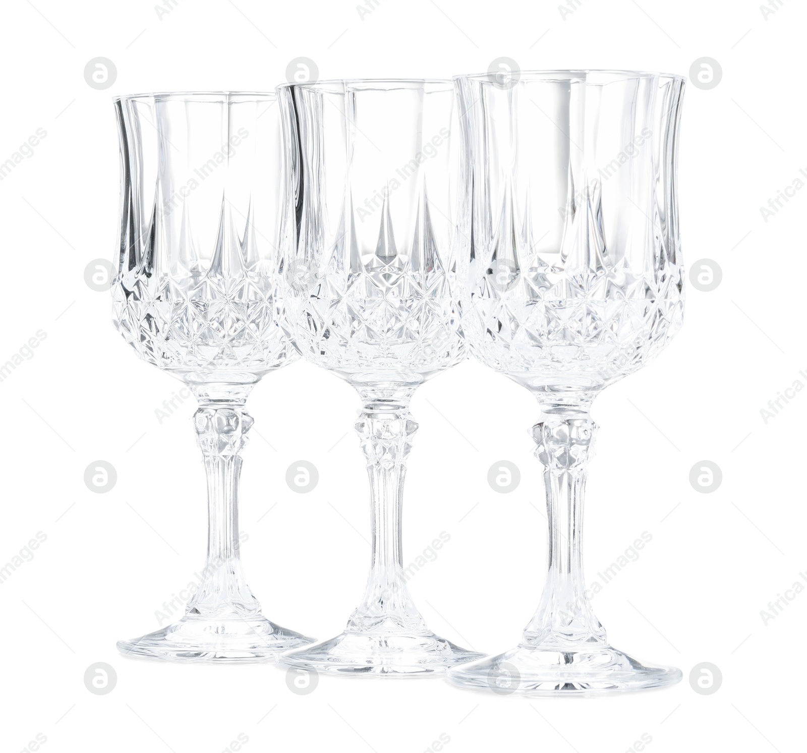 Photo of Three empty clean glasses isolated on white