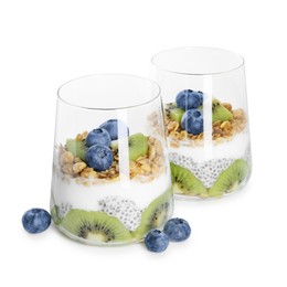 Photo of Delicious dessert with chia seeds, yogurt, granola, blueberries and kiwi in glasses isolated on white. Superfood
