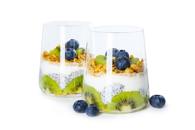 Photo of Delicious dessert with chia seeds, yogurt, granola, blueberries and kiwi in glasses isolated on white. Superfood